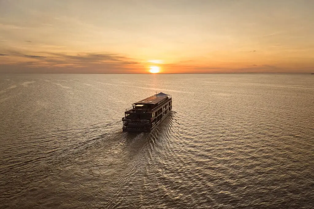 Traditional wooden boat on the Mekong River at golden hour