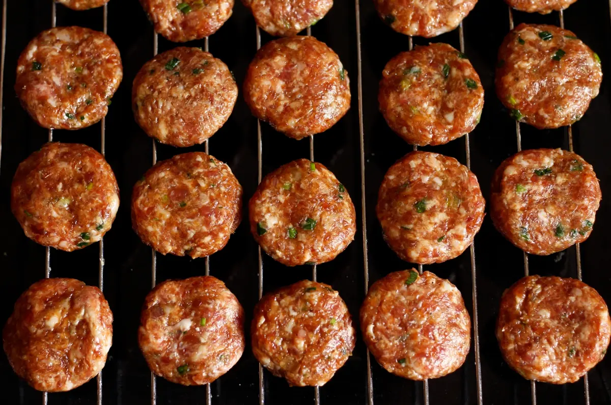 Grilling pork over charcoal for Bun Cha