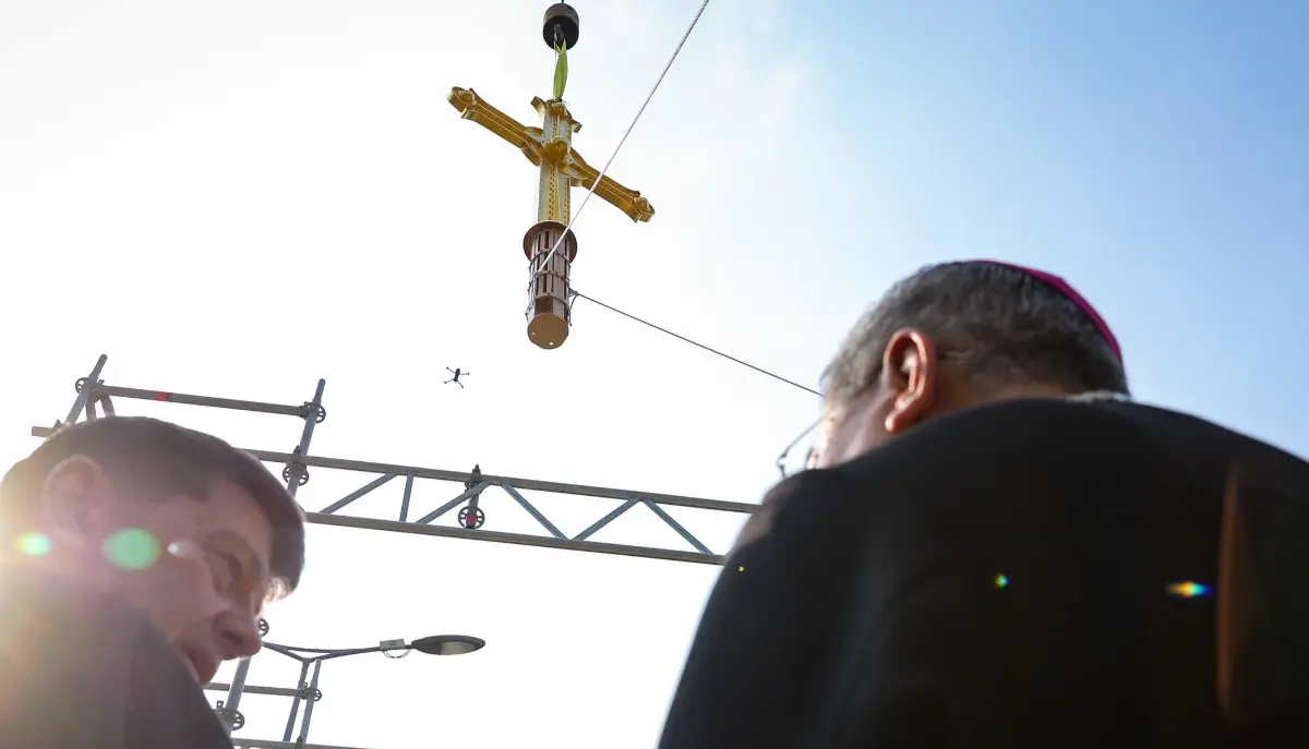 Golden cross being lifted to the spire of Saigon Notre-Dame Cathedral, March 2026