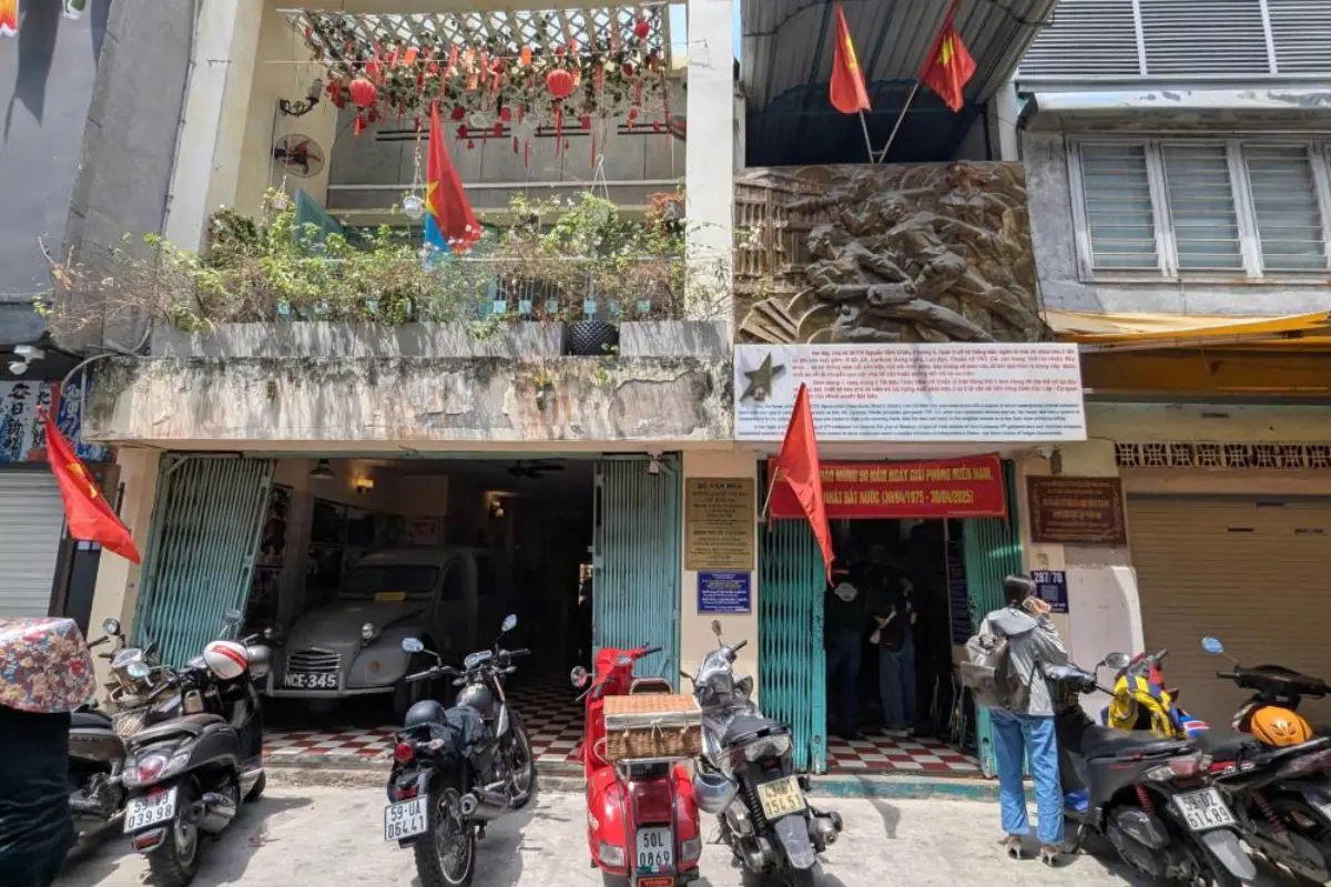 Narrow alleyway in District 3, Ho Chi Minh City, with old tube houses and motorbikes parked along the wall