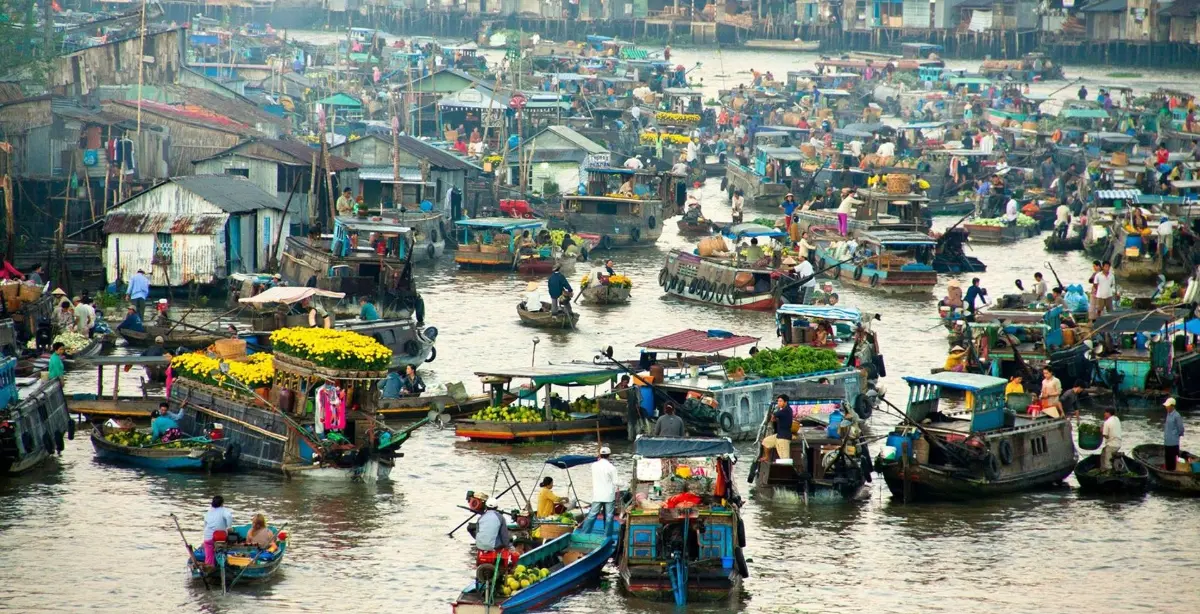 Traditional wooden boats at a floating market, Mekong Delta