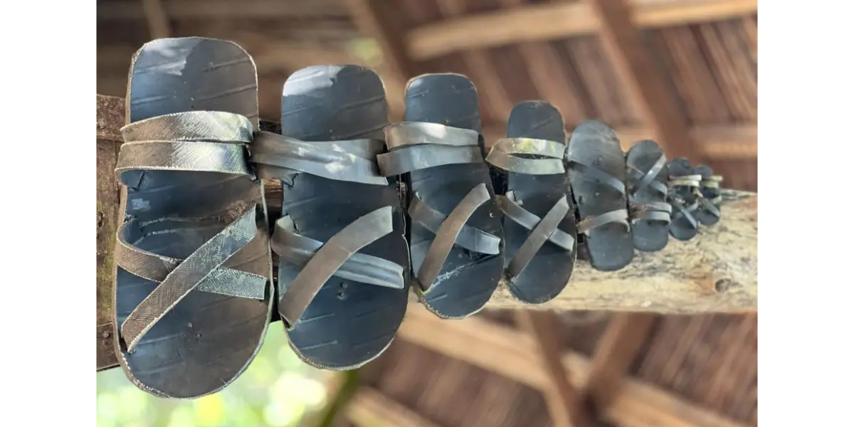 Close-up of handcrafted Vietnamese tyre sandals on wooden surface – dép cao su, cultural heritage