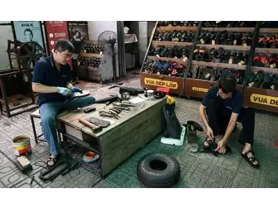 Artisan crafting traditional Vietnamese tyre sandals