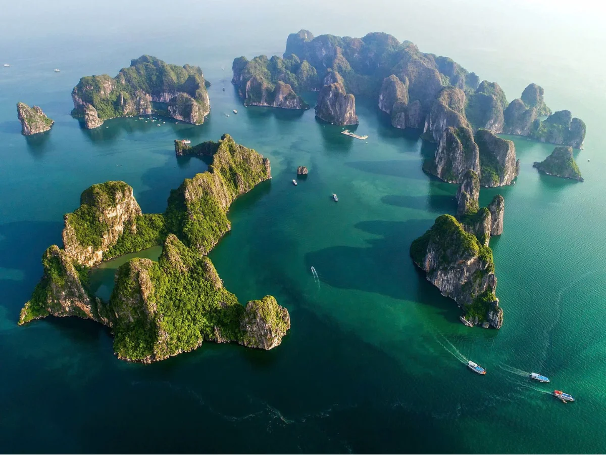 Golden sunrise over misty limestone karsts
